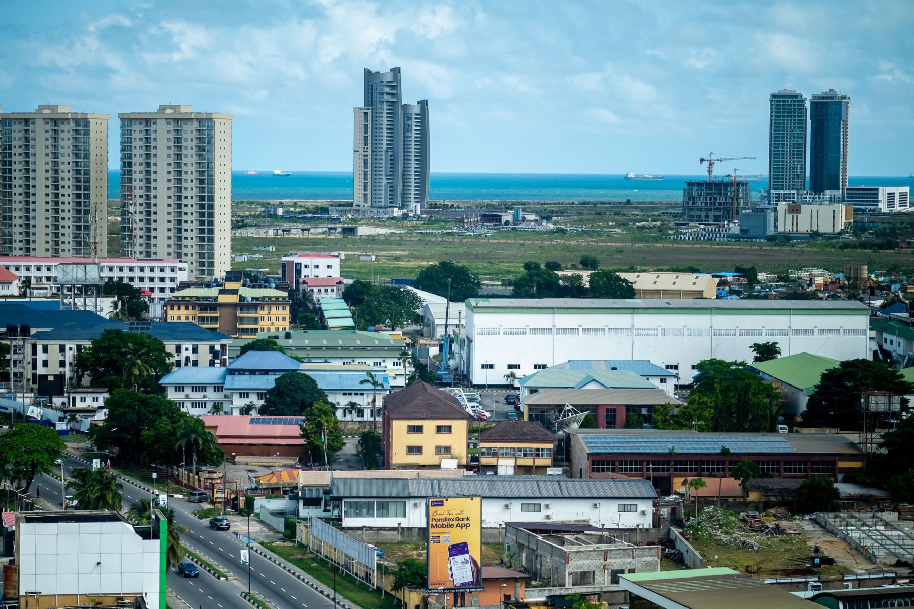 Aerial view of Lagos, Nigeria, with the ocean on the horizon.